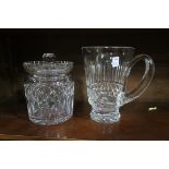 A WATERFORD CUT GLASS BISCUIT JAR together with a Waterford cut glass water jug