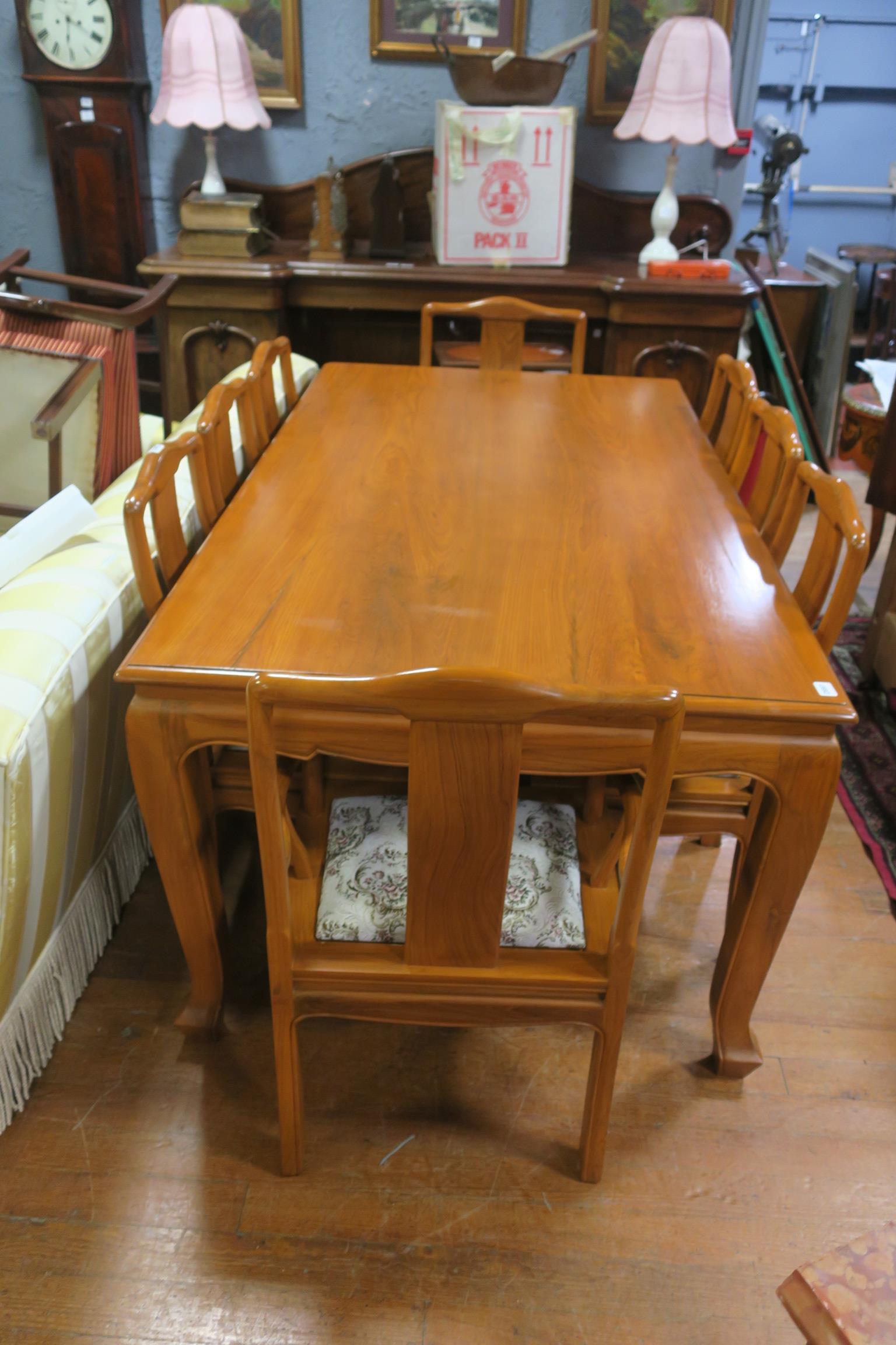 A NINE PIECE ORIENTAL HARDWOOD DINING SUITE comprising eight chairs including two elbow chairs each