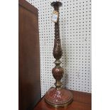 A PAIR OF CONTINENTAL GLAZED CHINA AND GILT BRASS CANDLESTICKS each with leaf capped baluster and