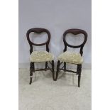 A SET OF FOUR 19TH CENTURY BEECHWOOD DINING CHAIRS each with an oval back on upholstered seat on