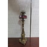 A FINE 19TH CENTURY CAST BRASS OIL LAMP with ruby glass and clear glass reservoir and etched glass