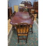 A NINE PIECE MAHOGANY DINING SUITE comprising of eight fork back dining chairs including a pair of