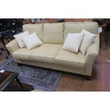 A CANADIAN STAINED WOOD AND GOLD UPHOLSTERED TWO SEATER SETTEE with loose cushions on shaped