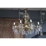 A GOOD CONTINENTAL GILT BRASS AND CUT GLASS EIGHT BRANCH CHANDELIER hung with faceted pendant THE