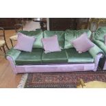 A LIGHT GREEN AND PINK THREE SEATER SETTEE,