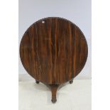 A VERY FINE REGENCY ROSEWOOD POD TABLE of circular outline with gadrooned rim above an octagonal