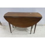 A GEORGIAN MAHOGANY DROP LEAF TABLE the oval hinged top raised on square tapering legs 74cm (h) x
