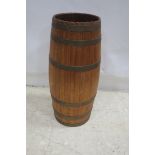 AN OAK AND BRASS BOUND BARREL of cylindrical form 64cm (h) x 24cm (d)