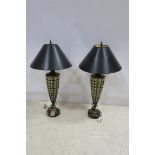 A PAIR OF GILT METAL AND GLAZED TABLE LAMPS each of vase form raised on a circular spreading foot