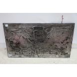 A METAL WALL MOUNTED EMBOSSED SIGN inscribed Bentley 56cm x 100cm