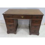 A CHIPPENDALE DESIGN MAHOGANY PEDESTAL DESK of rectangular outline the shaped top with gadrooned