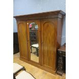 A 19TH CENTURY MAHOGANY THREE DOOR WARDROBE the outset moulded cornice above a central mirrored
