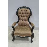 A 19TH CENTURY EBONISED AND PARCEL GILT ARMCHAIR the carved top rail above a deep buttoned