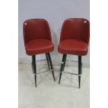 A PAIR OF RETRO REXINE AND UPHOLSTERED EBONISED IN CHROME HIGH STOOLS each with a shaped back and