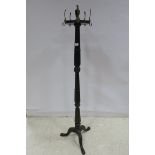 A 19TH CENTURY MAHOGANY COAT STAND the circular revolving top with brass lion mask hooks above a