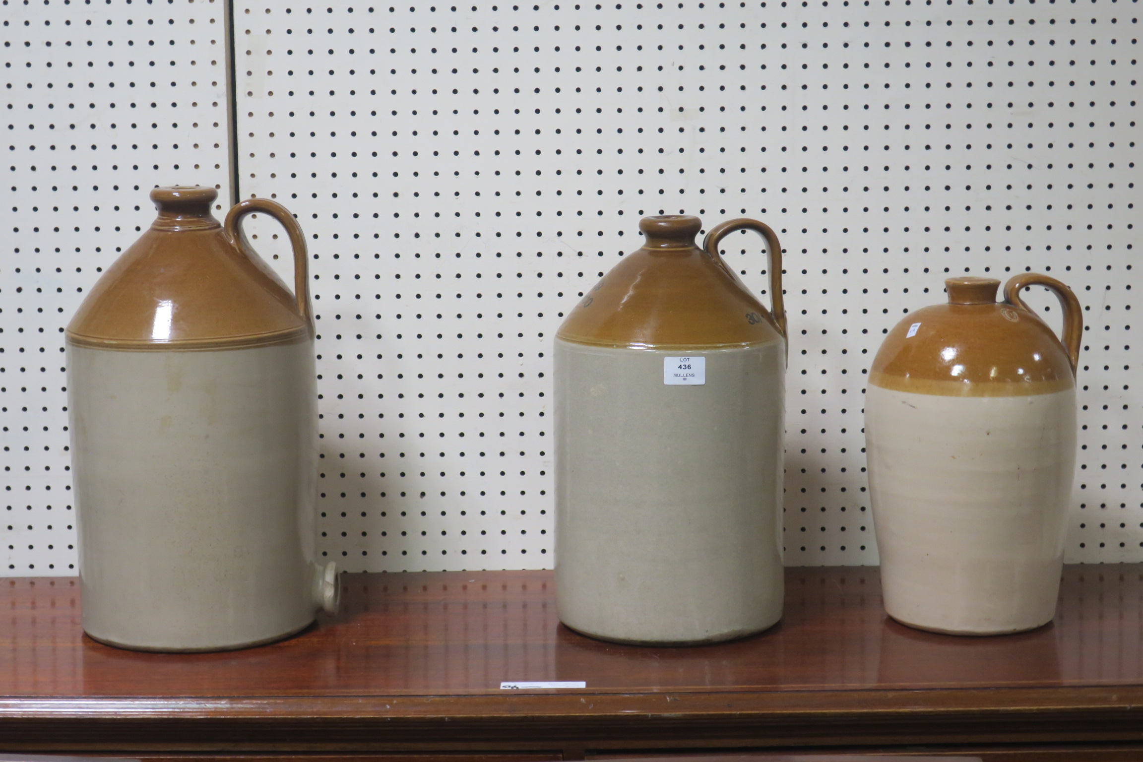THREE GLAZED EARTHENWARE WHISKY JARS inscribed Murray & Company Glasgow numbered 2 3 and 4