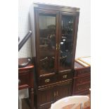 A CANADIAN STAINED WOOD AND BRASS BOUND DISPLAY CABINET of rectangular outline the shaped top above