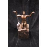 AFTER CAGAZO A BRONZED FIGURE modelled as a male shown kneeling with hands raised on a veined