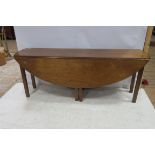 A GEORGIAN DESIGN MAHOGANY HUNT TABLE the oval hinged top raised on square moulded legs 75cm (h) x