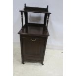 AN EDWARDIAN FUEL BIN the superstructure with moulded shelf above a hinged compartment on brass and