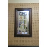 A FRAMED MIRROR depicting The Picwick Papers 51cm (h) x 31cm (w)