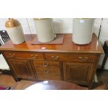 A MAHOGANY AND SATINWOOD INLAID SIDEBOARD of rectangular outline the shaped top above five frieze