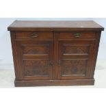 A 19TH CENTURY MAHOGANY SIDE CABINET the rectangular top above two frieze drawers and carved