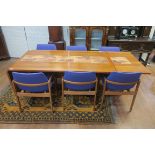A DANISH TEAK SEVEN PIECE DINING SUITE comprising six upholstered armchairs with moulded arms on