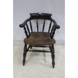 A STAINED WOOD BOWED SMOKER'S CHAIR the curved back with baluster splats and hide upholstered seat