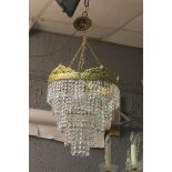 A CONTINENTAL GILT BRASS AND CUT GLASS FIVE TIER CENTRE LIGHT hung with faceted pendents