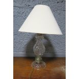 A CUT GLASS TABLE LAMP of baluster form raised on a circular spreading foot with shade 65cm (h)