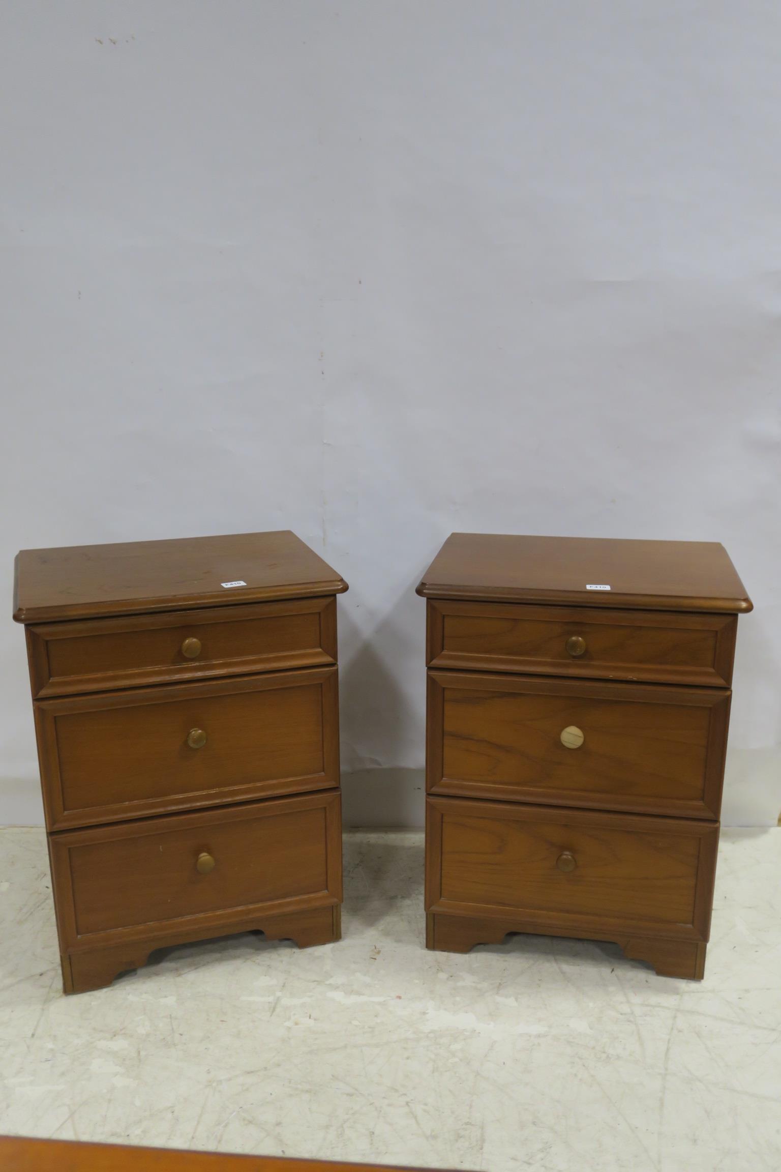 A PAIR OF ROSSMORE TEAK THREE DRAWER BEDSIDE CHESTS 74cm (h) x 56cm (w) x 42cm (d)