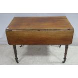 A 19TH CENTURY MAHOGANY DROP LEAF TABLE the rectangular hinged top with frieze drawer on turned