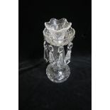 A WATERFORD CUT GLASS CANDLESTICK hung with faceted pendants above a baluster column on circular