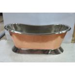 A VICTORIAN DESIGN COPPER AND POLISHED STEEL BATH of oval outline raised on a spreading foot 67cm