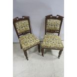 A PAIR OF 19TH CENTURY MAHOGANY AND UPHOLSTERED SIDE CHAIRS each with a scroll top rail above