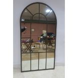 A VINTAGE METAL FRAME COMPARTMENTED MIRROR of rectangular arched outline 206cm x 109cm