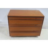 A CIRCA 1960s TEAK CHEST of three long drawers on castors 68cm (h) x 85cm (w) x 47cm (d)