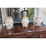 A SET OF THREE 19th CENTURY SPIRIT BARRELS, each of ovoid form moulded in relief with foliage,