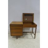 A CIRCA 1960s TEAK DRESSING TABLE of rectangular outline with hinged compartment and three frieze