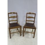 A SET OF FOUR CIRCA 1930s OAK DINING CHAIRS each with ladder back and upholstered drop in seat on