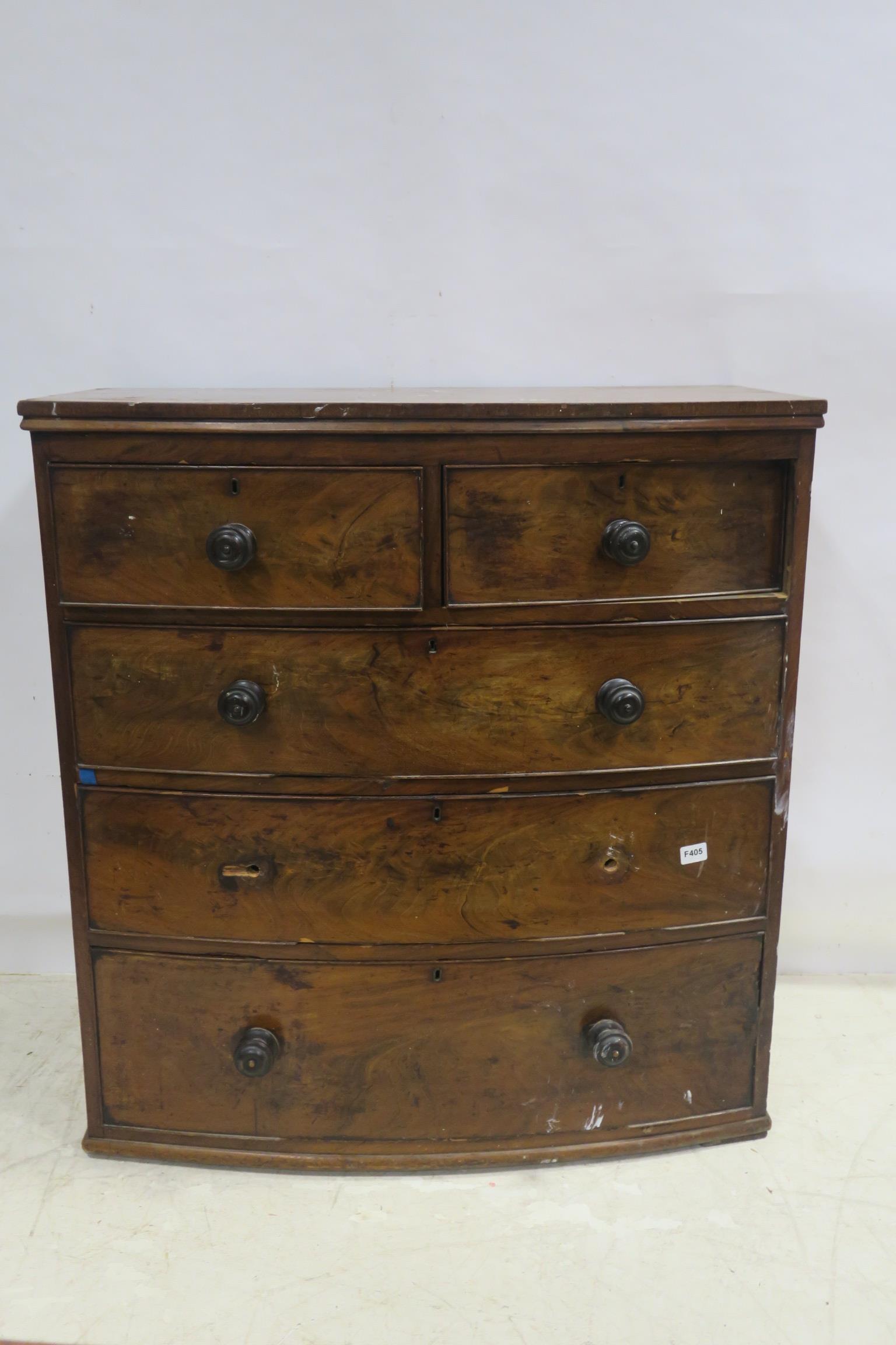 A 19TH CENTURY MAHOGANY CHEST of demilune outline with two short and three long drawers on moulded