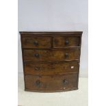 A 19TH CENTURY MAHOGANY CHEST of demilune outline with two short and three long drawers on moulded