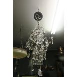 A CONTINENTAL CUT GLASS CENTRE LIGHT hung with faceted chains and pendant drops