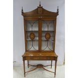 A VERY FINE SATINWOOD AND POLYCHROME DISPLAY CABINET the shaped pediment with urn finials above a