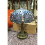A TIFFANY DESIGN BRONZED LEAD GLASS AND COLOURED GLASS TABLE LAMP the domed shade with