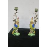 A PAIR OF CONTINENTAL GILT BRASS PORCELAIN FIGURAL CANDLESTICKS each modelled as a parakeet 40cm