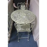 A THREE PIECE WROUGHT IRON PATIO SUITE comprising a pair of folding chairs together with a circular