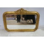 A CONTINENTAL GILT FRAMED MIRROR the bevelled glass plate within a foliate flower head frame with