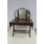 A REGENCY DESIGN MAHOGANY DRESSING TABLE the superstructure with triptych mirror above a